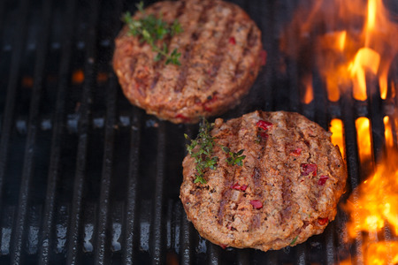 food meat - burgers on party summer barbecue grill with flame. Live action shotの写真素材