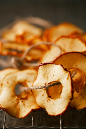Dried apple slices and wooden backdropの写真素材