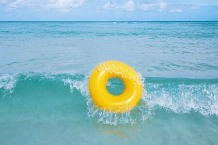 floating ring on blue sea wave with sky, shallow dofの写真素材