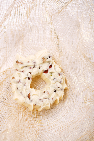 white chocolate festive christmas wreath on table with glitter napkinの写真素材