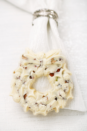 white chocolate festive christmas wreath on table with glitter napkinの写真素材