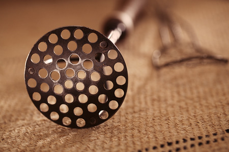real vintage iron with wooden handle potato mashers on old grain sacking linen Completely hand made  handwoven and homespunの写真素材