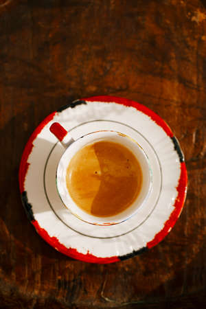 espresso coffee shot in retro cup on vintage wooden tableの写真素材