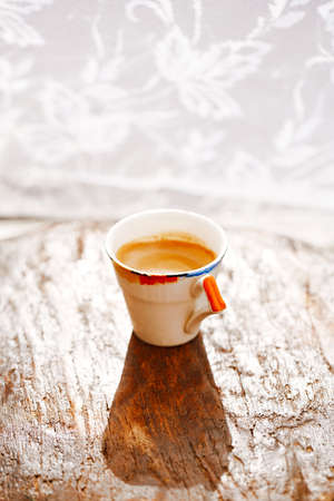 espresso coffee shot in retro cup on vintage wooden tableの写真素材