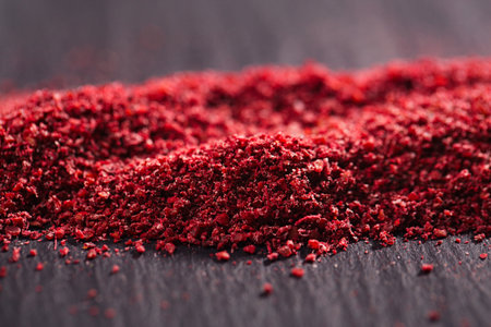 Ground Red Sumac Berries spice on black plate