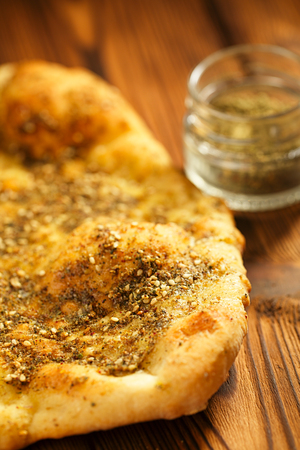Zaatar spice mix with naan bread - traditional Middle Eastern blend made with thyme, sesame seeds, salt, sumac, oregano, cumin, fennel seeds and marjoramの写真素材