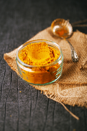 turmeric latte spice mix on dark backgroundの写真素材