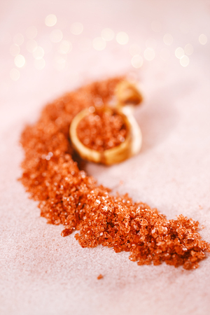 Hawaiian Red Gold Salt with wooden spoon on pink marbleの写真素材