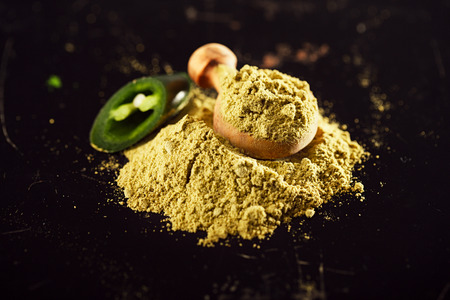 Jalapeno Green Chilli Powder on dark backgroundの写真素材