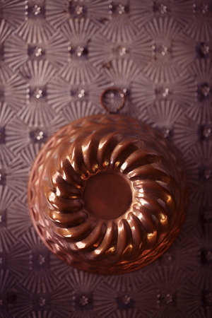 vintage copper baking mold on metal backdropの写真素材
