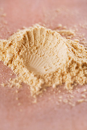 Ginger powder very fine and aromatic on pink marbleの写真素材