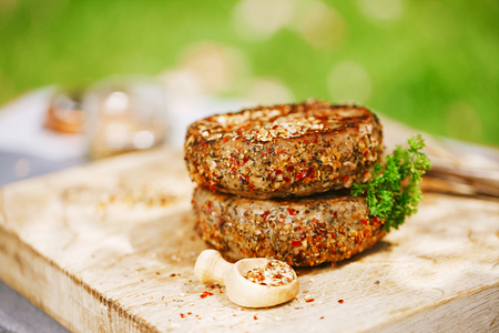 lamb burgers spiced by mint and lamb rub on wooded boardの写真素材