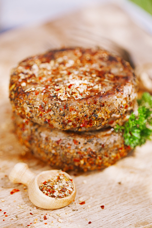lamb burgers spiced by mint and lamb rub on wooded boardの写真素材