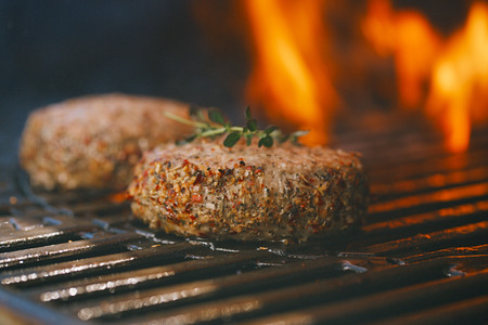 lamb burgers spiced by mint and lamb rub on bbq grill with flameの写真素材