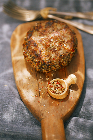 lamb burgers spiced by mint and lamb rub on wooded boardの写真素材