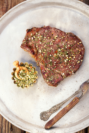 garlic chilli spice blend with bbq grilled  beef steak on plateの写真素材