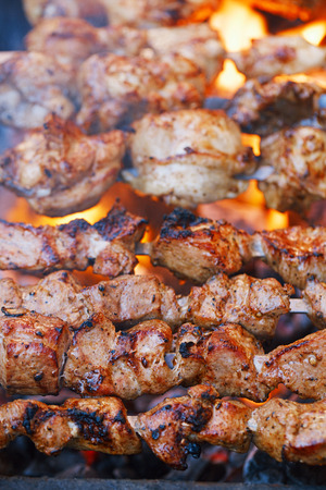 meat kebab shashlik on skewers  and grill with flameの写真素材