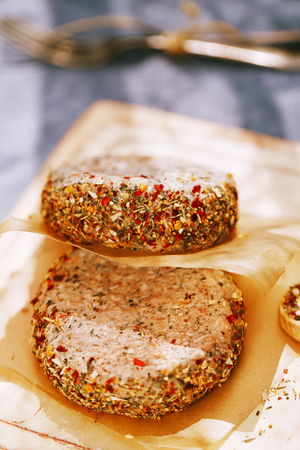 lamb burgers spiced by mint and lamb rub on wooded boardの写真素材
