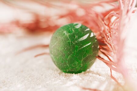 sea glass marble with red corall  on white sand beach with seascapeの写真素材