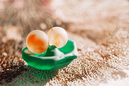 sea glass and marble  on coral with white sand beach  seascapeの写真素材