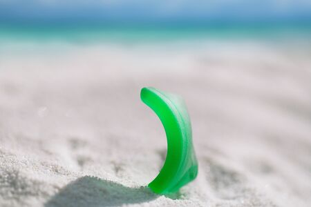 sea glass on white sand beach with seascapeの写真素材