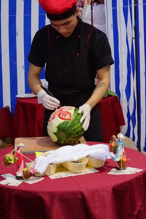 Man carves rose on watermelonのeditorial素材
