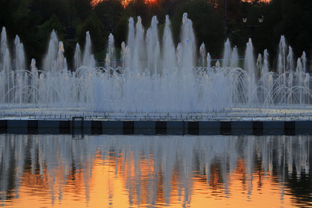 Fountain in the light of the setting sun.の写真素材