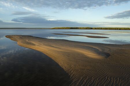 Morning calm river and the sand alluvium. Lena river. Yakutia. Russia.の写真素材