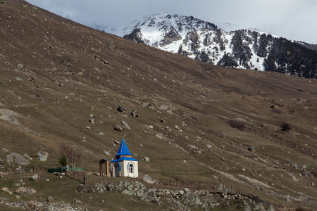 A small chapel with a blue roof in the mountains. North Ossetia. Russia.