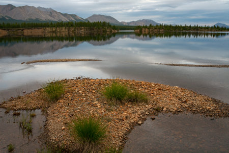 Mountain lake with an island in the foreground. Lake Darpir. Yakutia. Russia.の写真素材