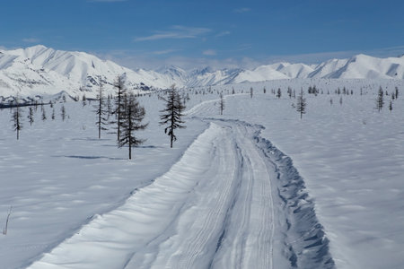 Winter road in the snowy mountains. Moma Mountains. Yakutia. Russia.の写真素材