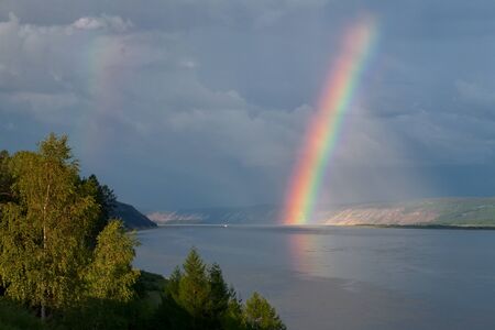 The bright rainbow over the big river. Lena river. Yakutia. Russia.の写真素材