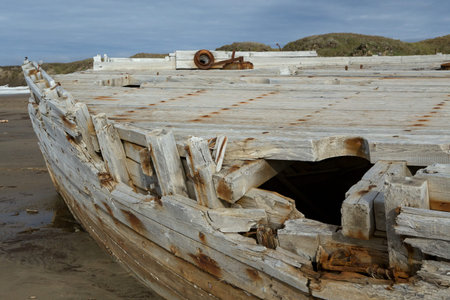 Old wooden ship stranded on a sandy beach. Laptev sea. Yakutia. Russia.の写真素材