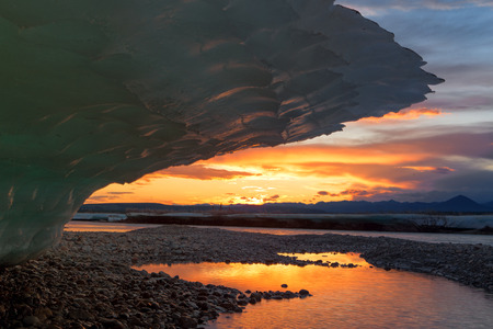 Large ice-visor and the sunset on the horizon. Moma River. Yakutia. Russia.の写真素材