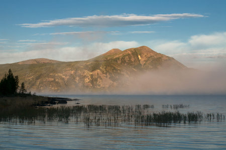 Morning fog over a mountain lake. Lake Labynkyr. Yakutia. Russia.