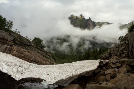 Snowy bridge over mountain creek. National Park Ergaki. Western Sayan. Krasnoyarsk region. Russia.の写真素材
