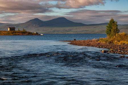 Cabin by the lake and the beginning of the river. Lake Labynkyr. Yakutia. Russia.