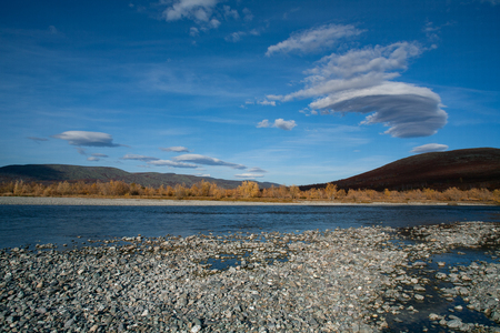 Lenticular clouds over autumn river. River Paypudina. Polar Urals. Russia.の写真素材