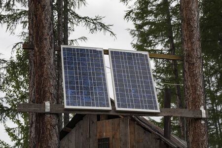 Solar cells on the tree in the forest. The use of solar energy in the taiga area. The Republic Of Sakha, Russia.の写真素材