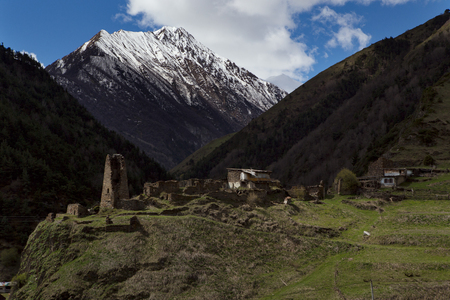 Old stone Ossetian settlement on the background of mountains. Of North Ossetia. The Caucasus. Russia.の写真素材