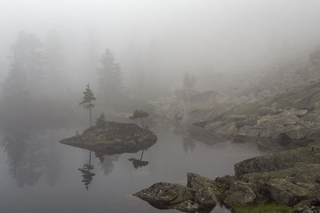 Mountain lake in the fog. Western Sayan. Natural Park Ergaki. Krasnoyarsk region. Russia.の写真素材