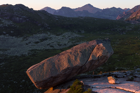 A large boulder on the edge of the abyss. Western Sayan. Natural Park Ergaki. Krasnoyarsk region. Russia.の写真素材
