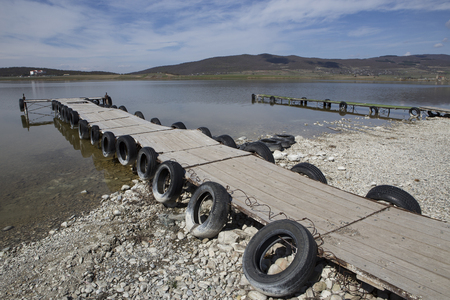 The longest pier on the pond with old car tires. Recreation area in Georgia.の写真素材
