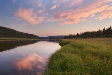 Red clouds over boreal river. The River Amga. Yakutia.の写真素材