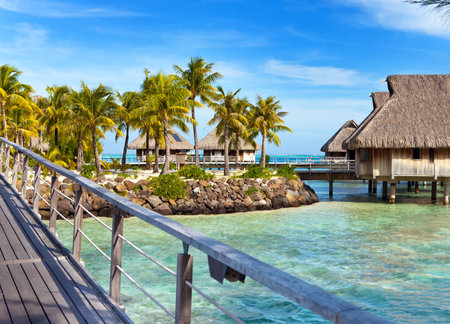 The wooden bridge to a hut over water at the ocean