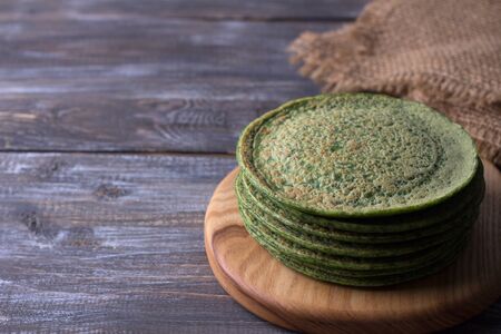 Spinach pancakes on a wooden board, rustic style, free space, selective focusの写真素材