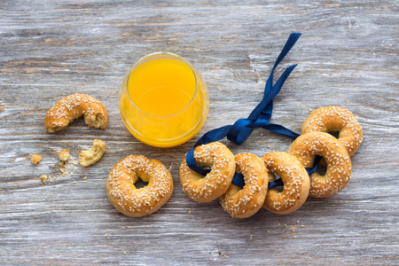 Traditional Greek Easter biscuits Paskhalina Kuluria with sesame seeds on a wooden table, selective focus. Delicious homemade pastriesの写真素材