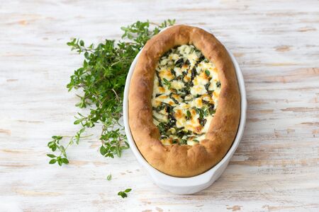 Open cheese chard pie with thyme  in Adjara style on the wooden table, top view. Delicious homemade foodの写真素材