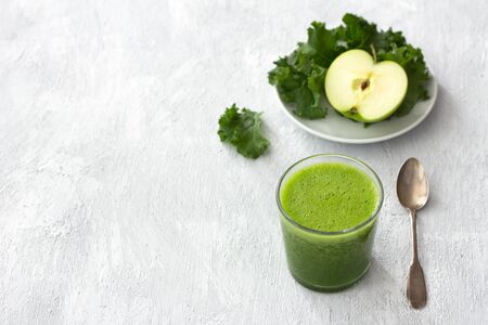 Green smoothie with kale cabbage and apple on a gray background. delicious healthy vegan foodの写真素材