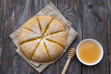 Freshly baked carrot scones with honey on a wooden table, top view, horizontalの写真素材